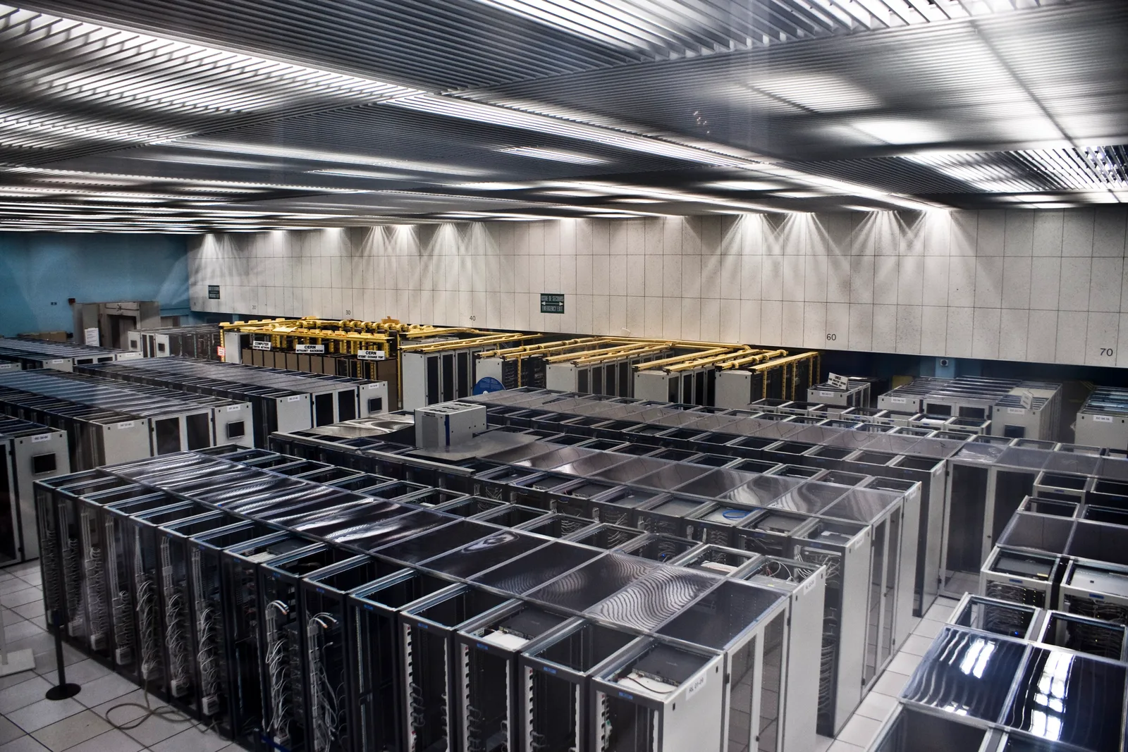 Long rows of server racks with cabling in the CERN computing centre