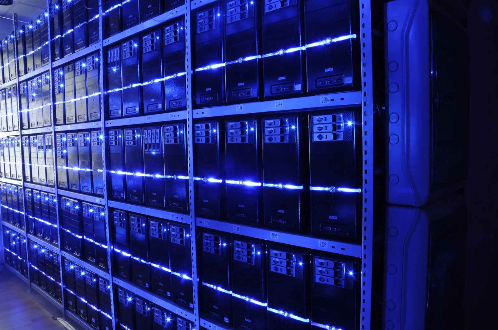 Server room aisle with racks of servers and overhead cable trays at BalticServers