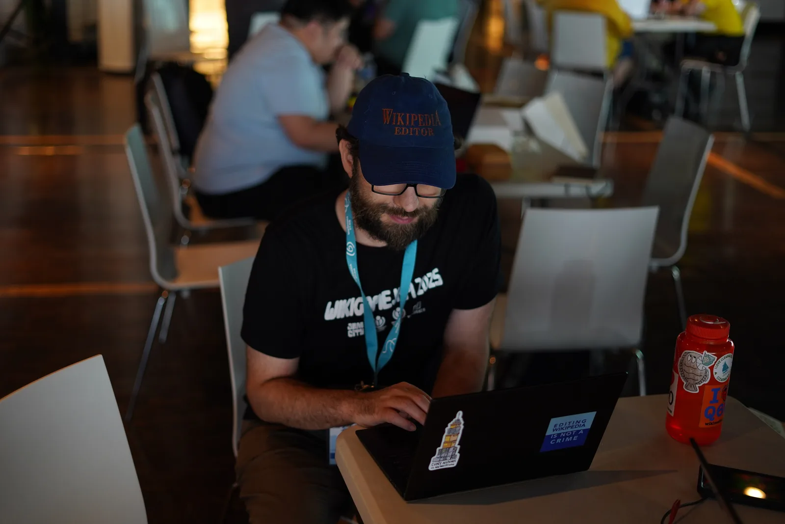 Group of technical volunteers working together on laptops around a shared table