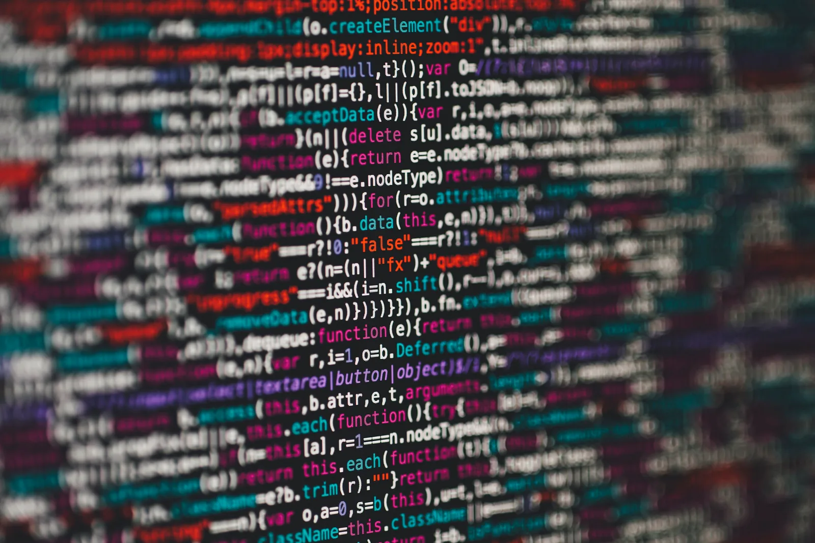 Close-up of a monitor displaying HTML and PHP source code in a text editor