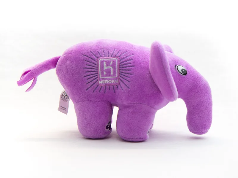 Purple plush elephant toy, the PHP elePHPant mascot, standing on a white background