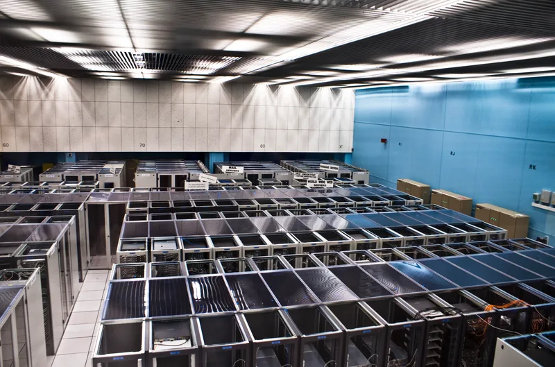 Rows of rack-mounted servers with cables in a data centre