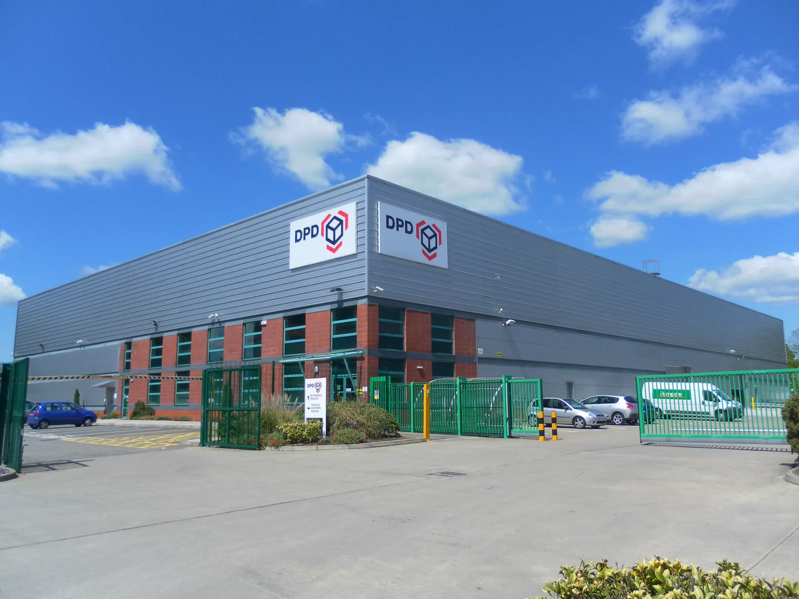 Exterior of a DPD parcel distribution warehouse with loading bays in Crawley, England