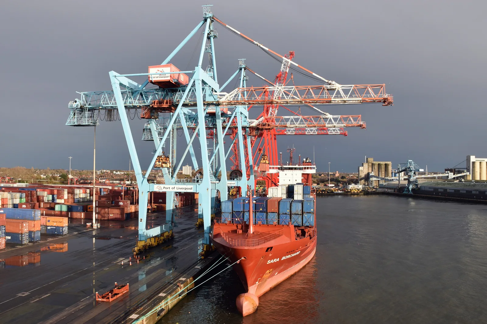 Container cranes and rows of stacked containers at Seaforth Container Terminal in Liverpool