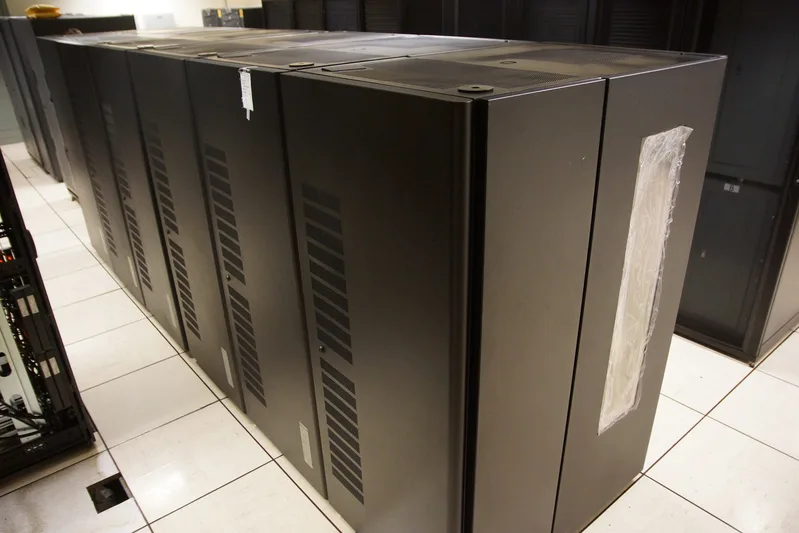 Overhead view of a large IBM TS3500 tape library with rows of storage cartridges
