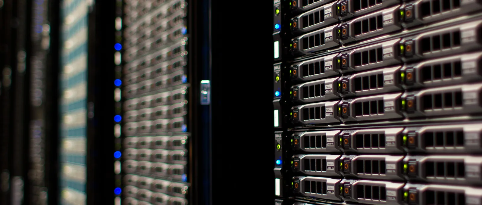 Front panels of rack-mounted servers with status lights in a server room