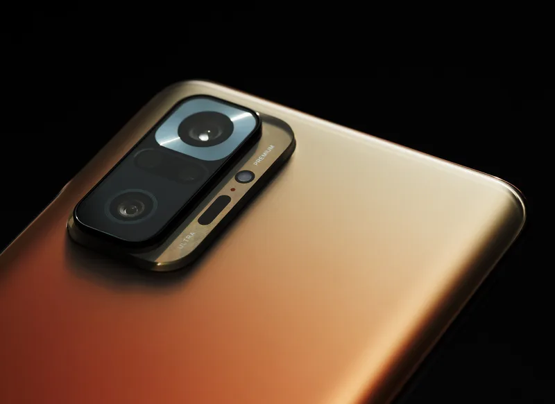 Close-up of the back of a bronze-coloured smartphone showing its camera module