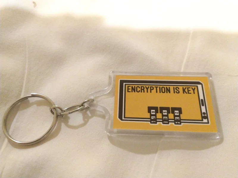Yellow key ring tag printed with the words Encryption is key
