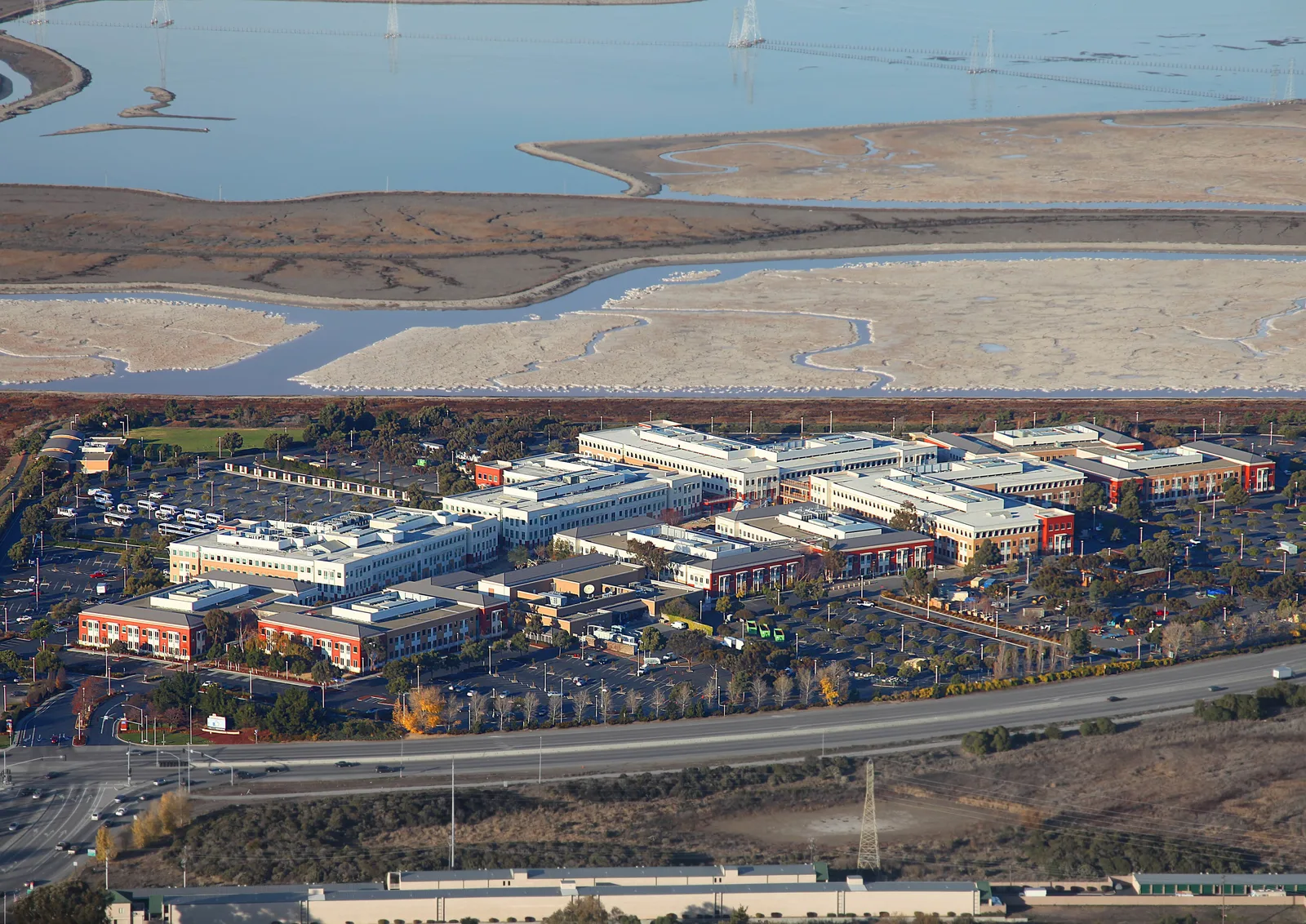 Aerial view of the former Facebook headquarters office buildings and car parks in Menlo Park beside the salt marshes of San Francisco Bay