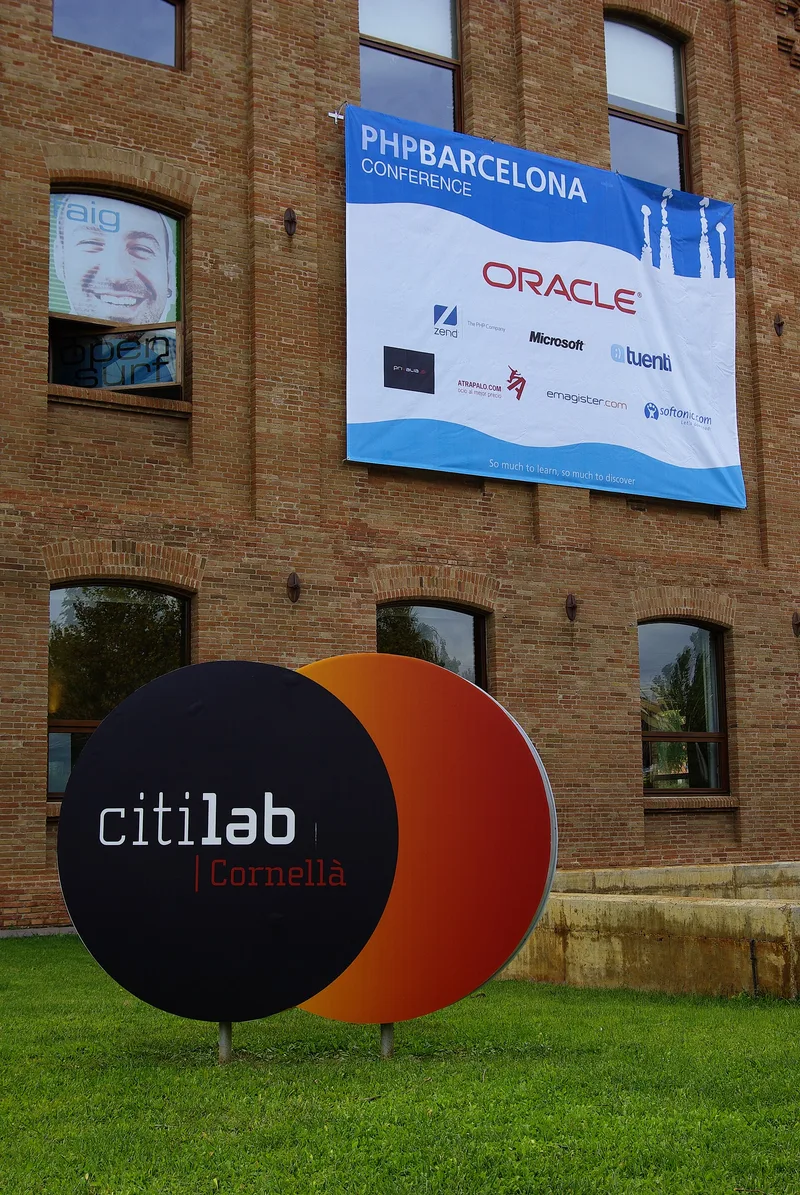 PHP Barcelona Conference banner on a brick building above a round Citilab Cornellà sign