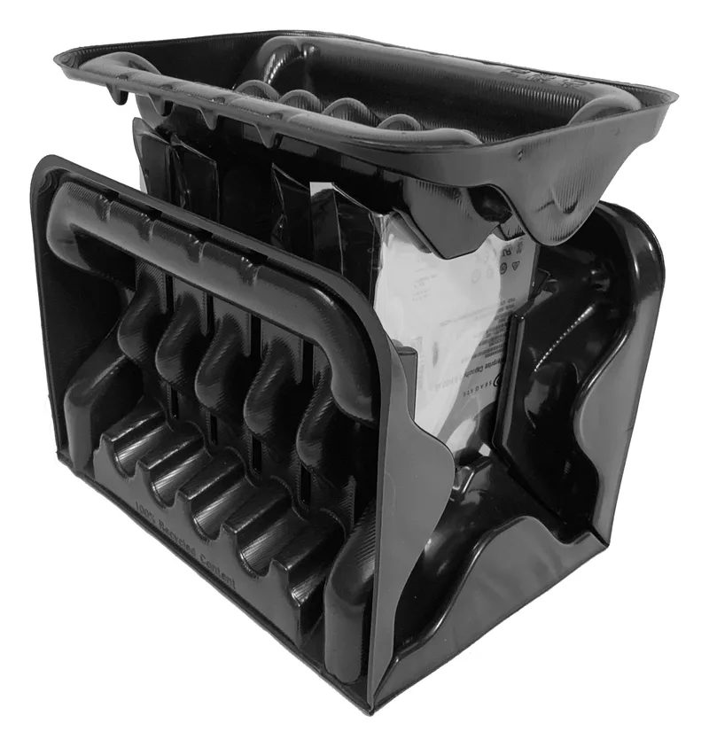 Black-and-white photo of enterprise hard drives in moulded recycled-plastic packaging