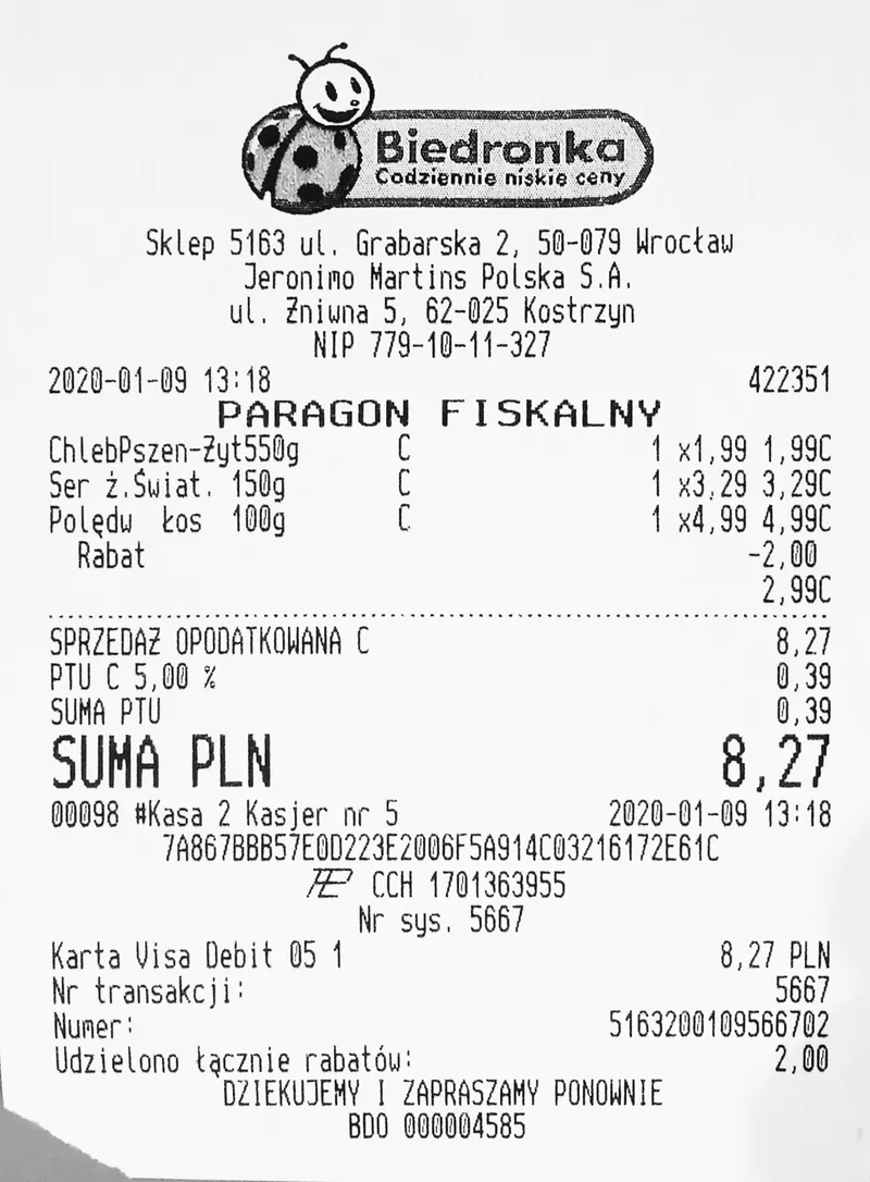 Printed supermarket receipt from a Biedronka shop in Wrocław listing three items, a discount, a 5% VAT line and a total of 8.27 PLN