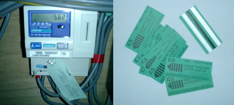 A Siemens electricity prepayment meter on a wall beside a pile of green five-pound prepayment token cards with magnetic stripes